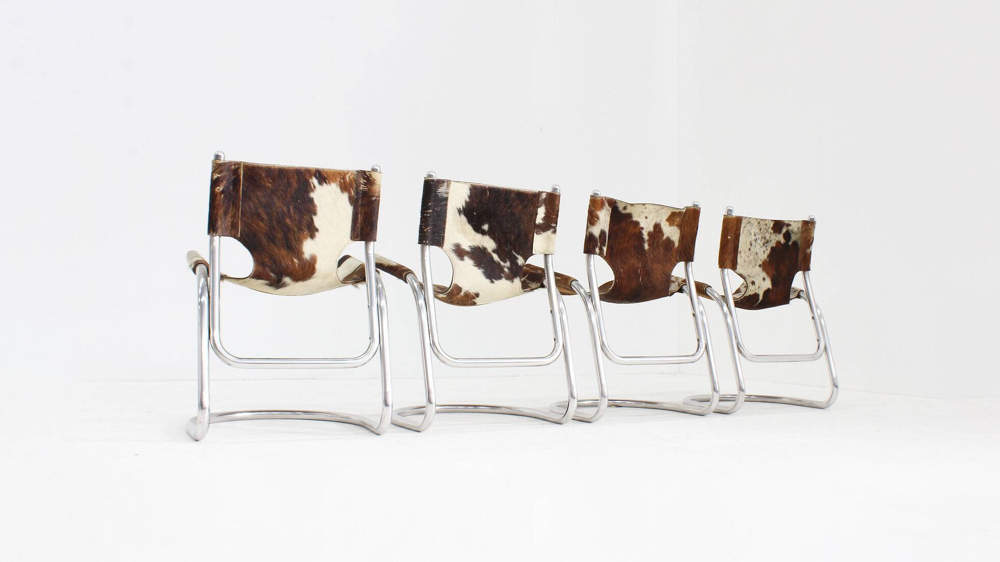 Vintage dining room chairs chrome and cowhide by Parravicini Fratelli