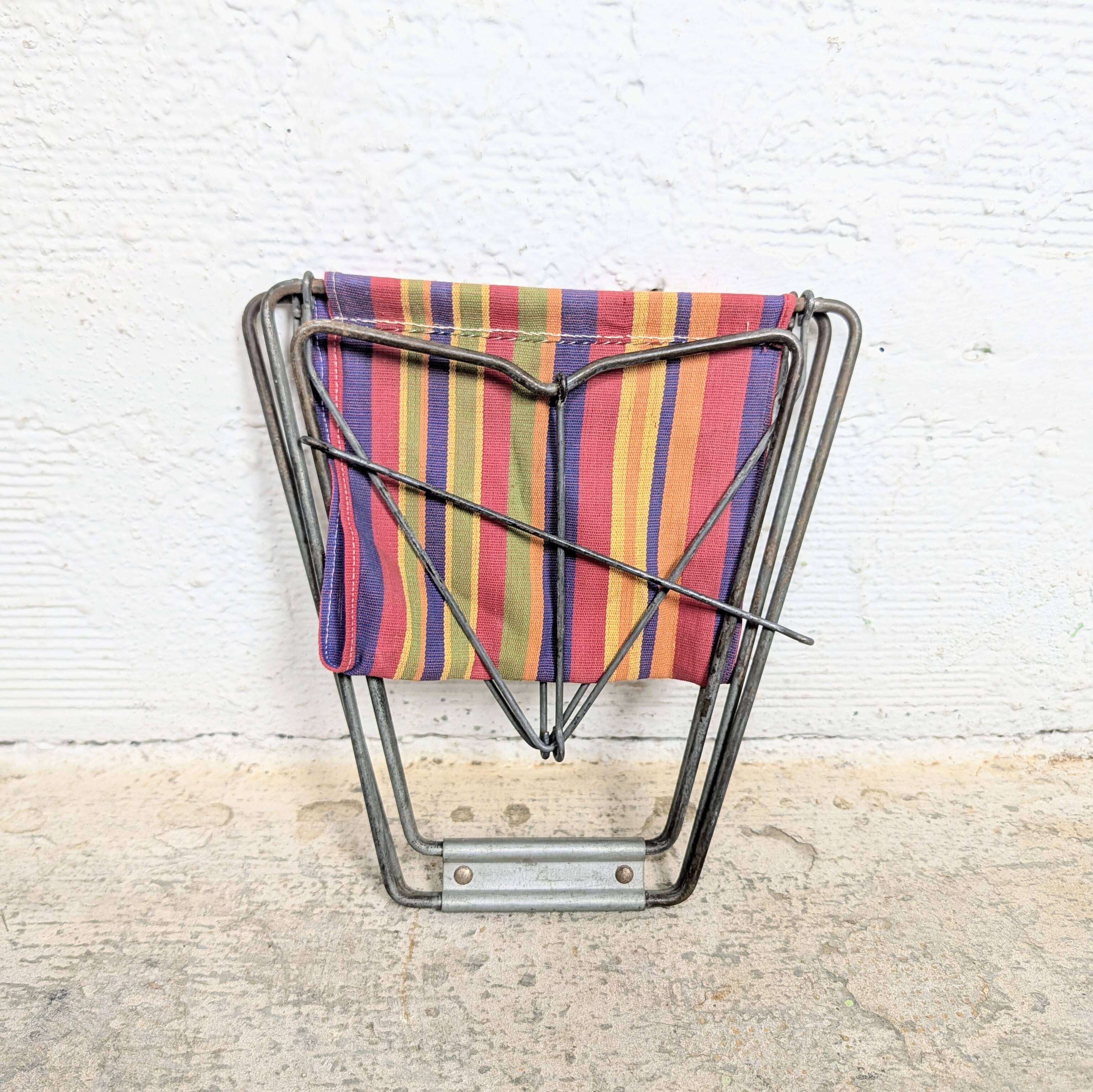 Vintage folding stool with a bayadère fabric pattern.
