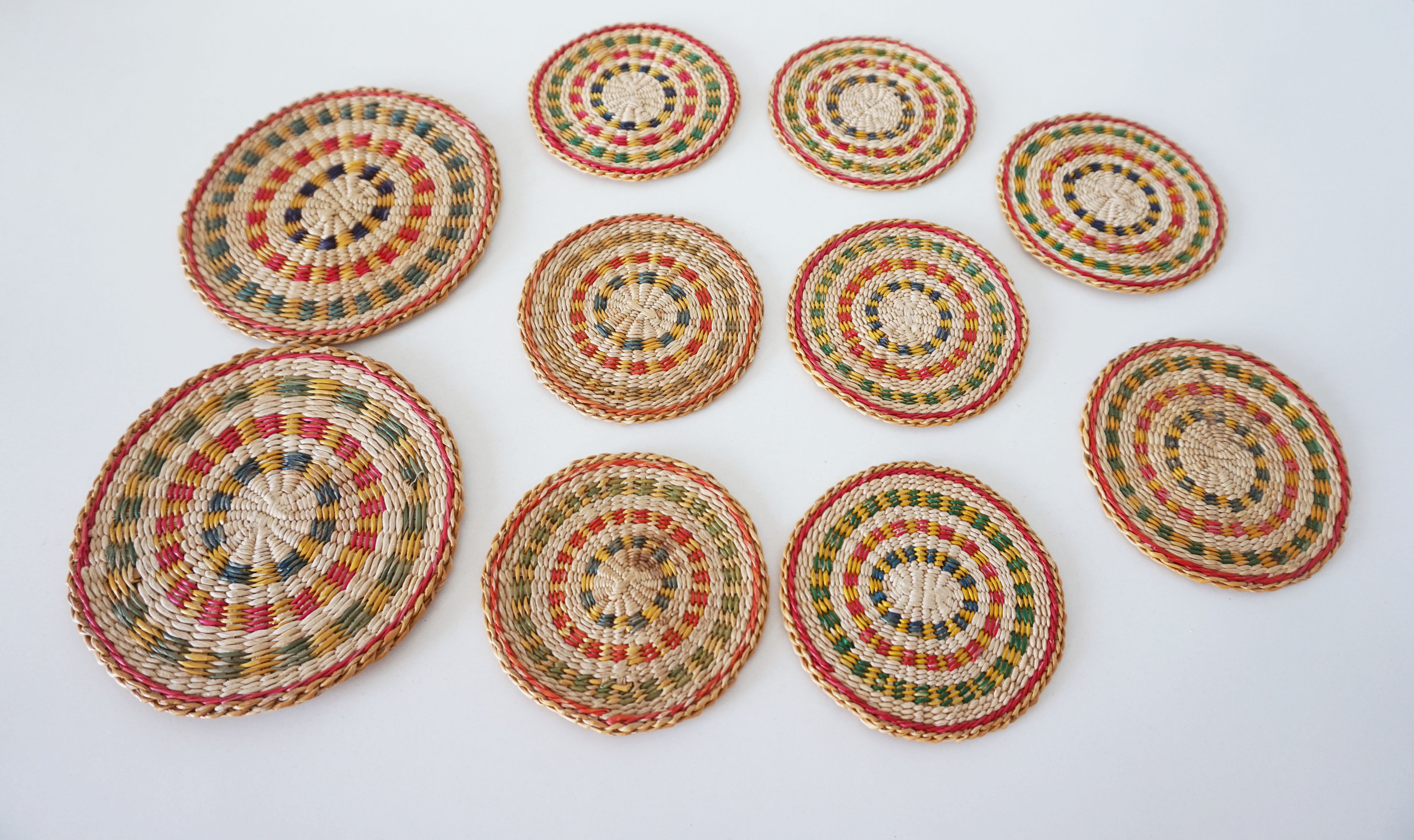 Set of coasters and bottles in colored wicker