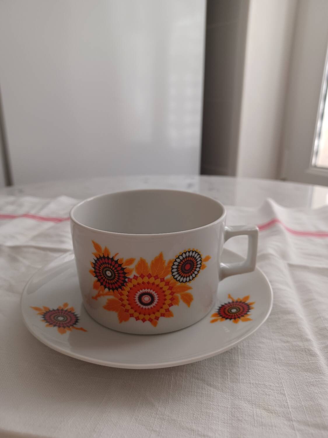 Vintage orange patterned cup and saucer