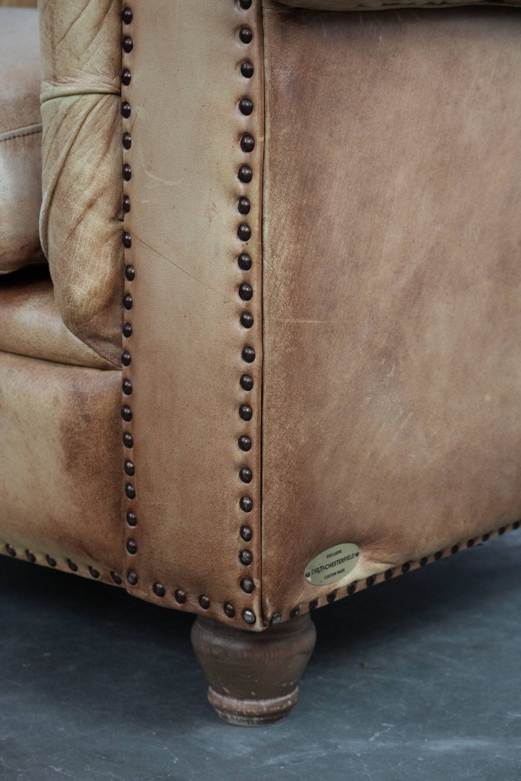 Chesterfield armchair made of cowhide leather in a light cognac colour