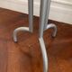 Metal and glass tripod pedestal table