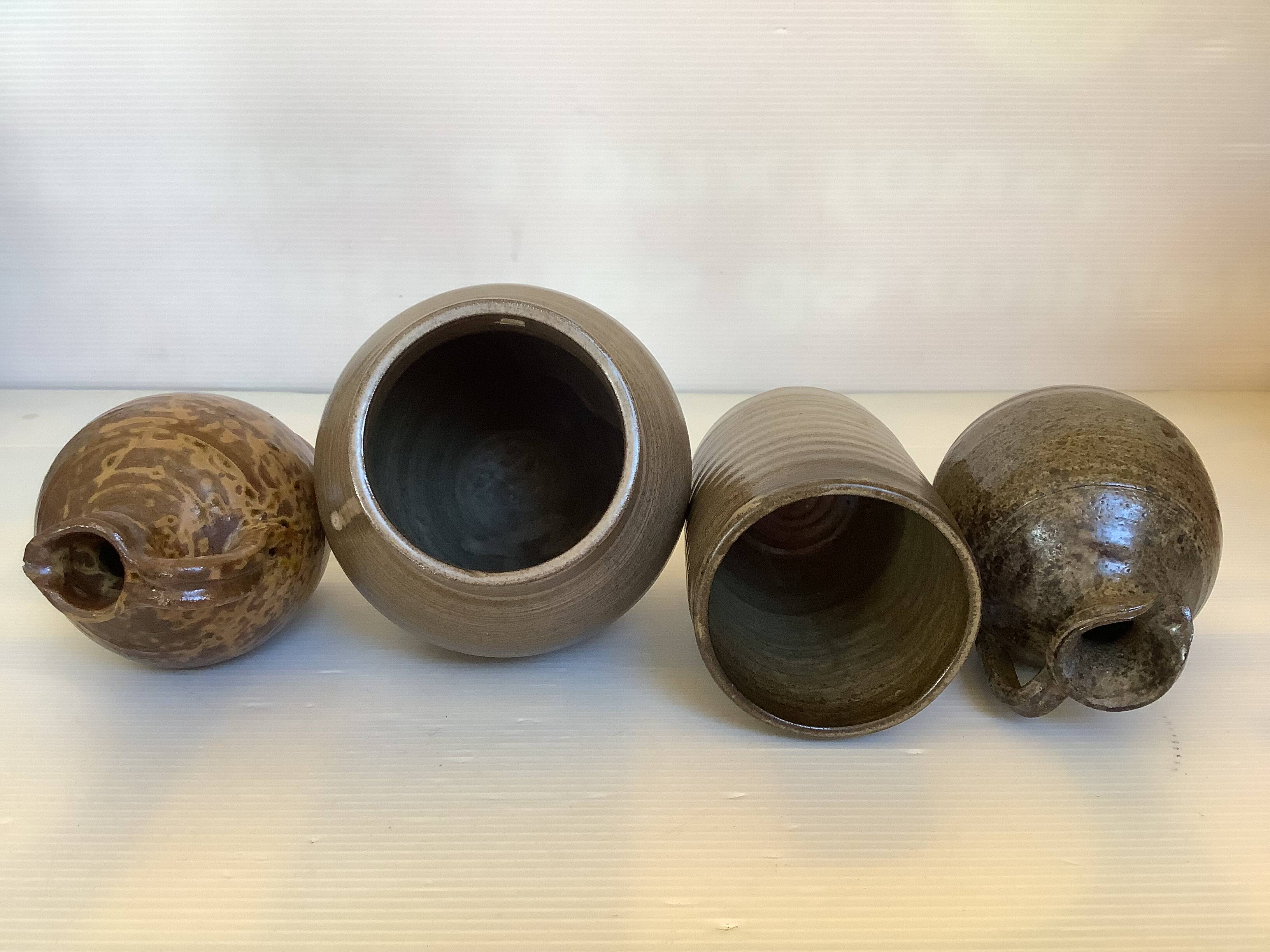 Eight brown ceramic pitcher vases