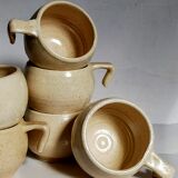 Six vintage potter's ceramic cups with vanilla enamel