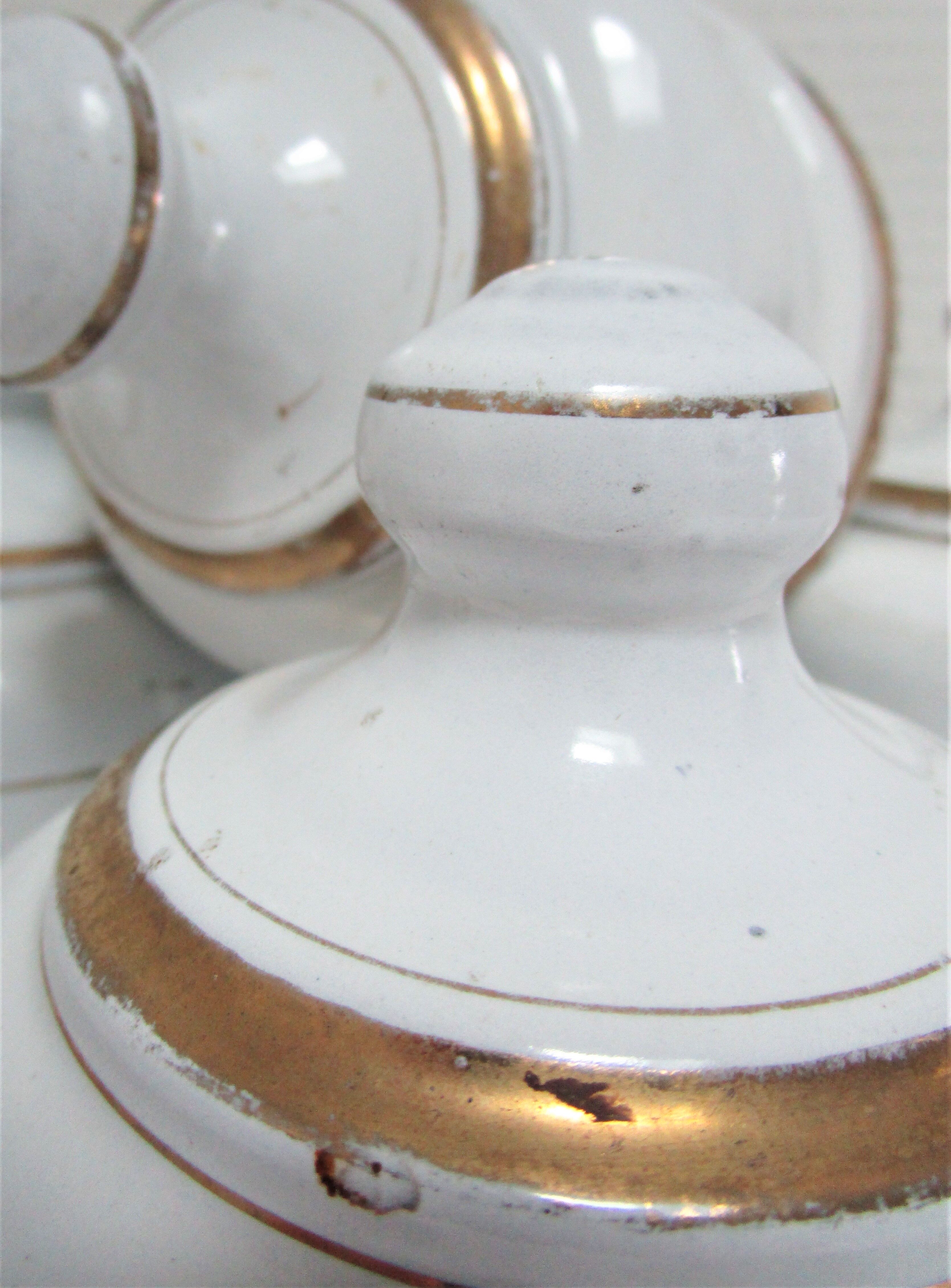Four white enamelled metal cheese bells early twentieth century
