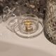 2 transparent glass butter dishes accompanied by their matching cloches.