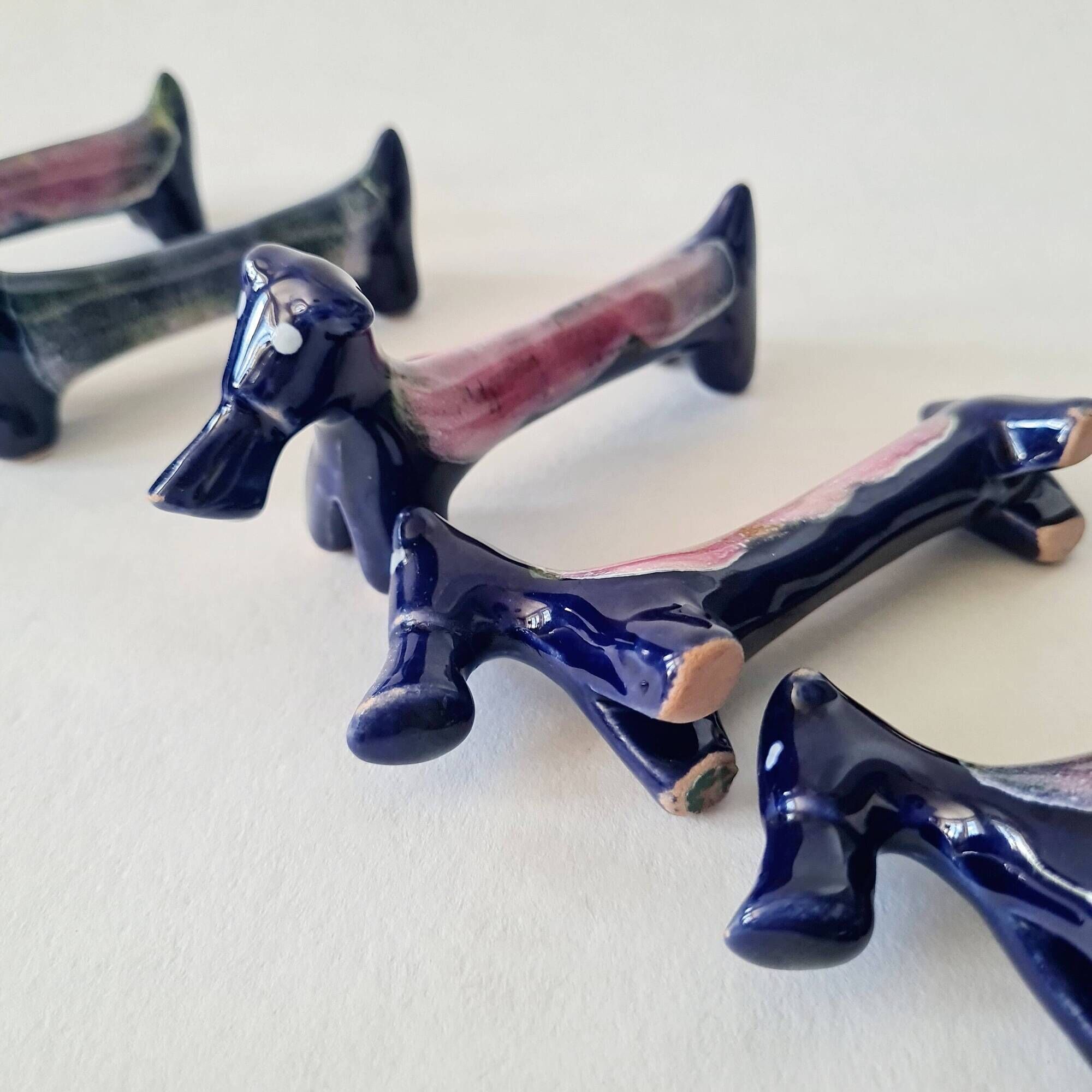 Set of 8 vintage ceramic knife rests, retro dog design.