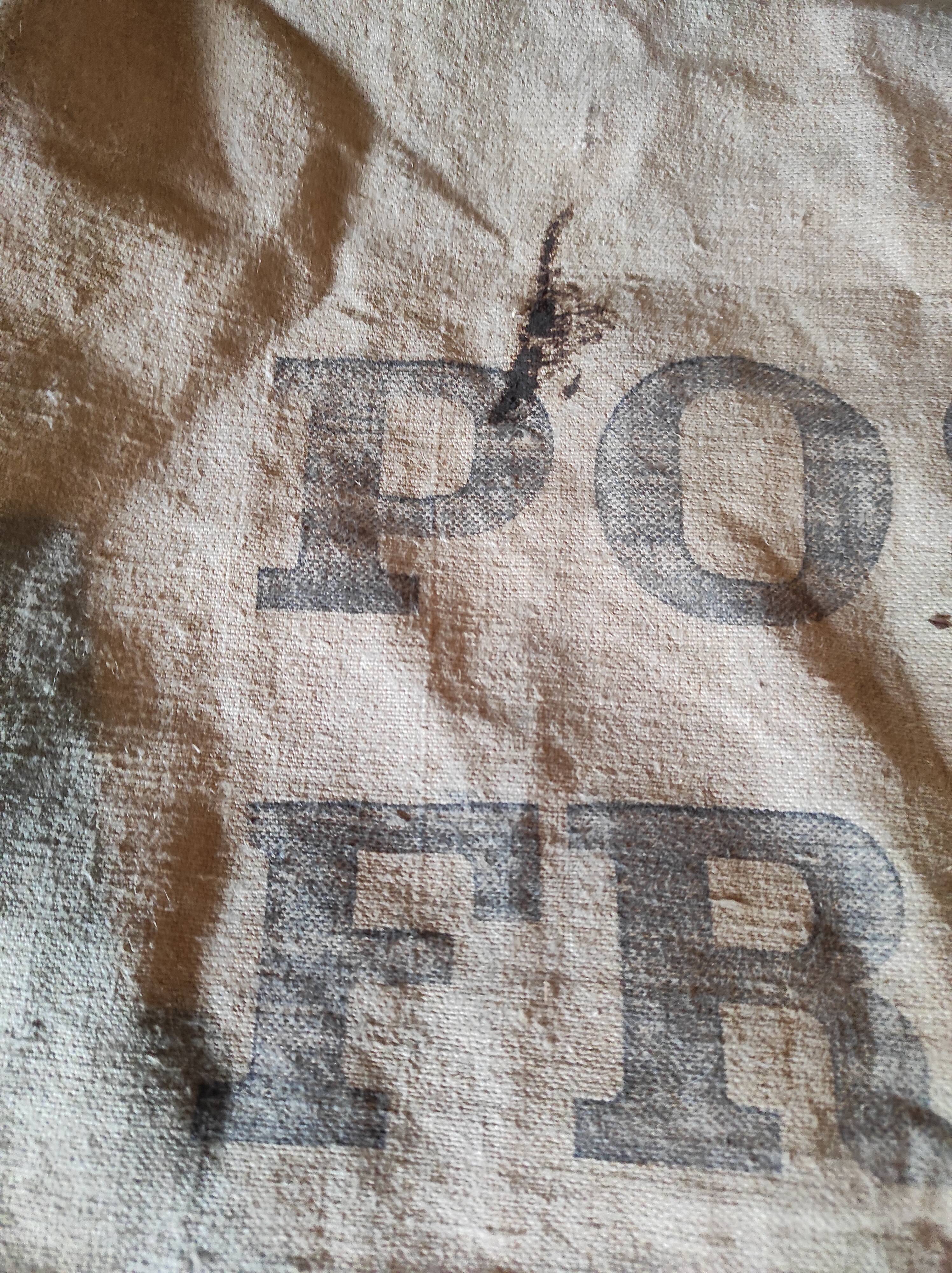Vintage postal bag trade object of La Poste in mixed-race canvas burlap