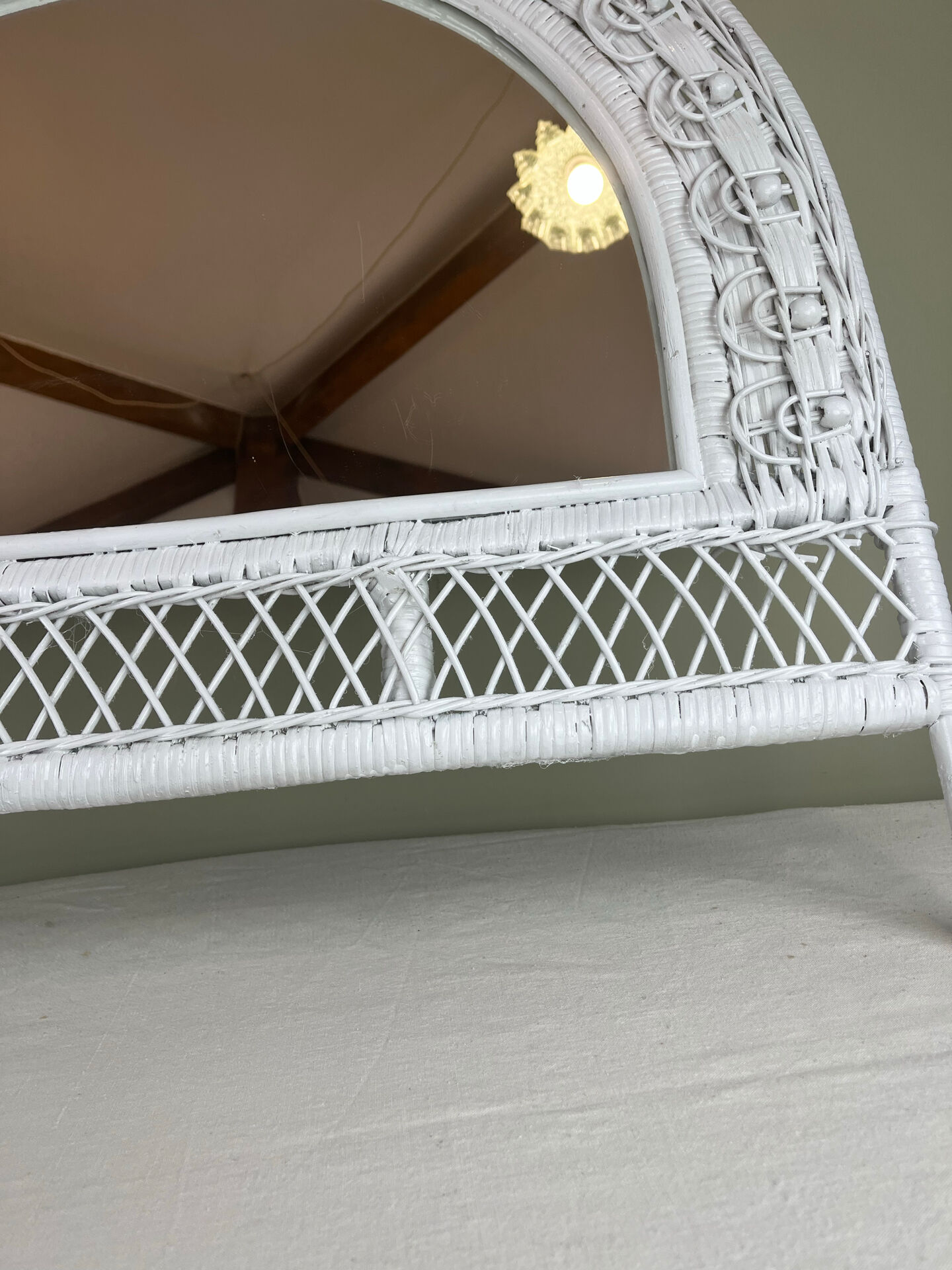 Half-moon wicker mirror