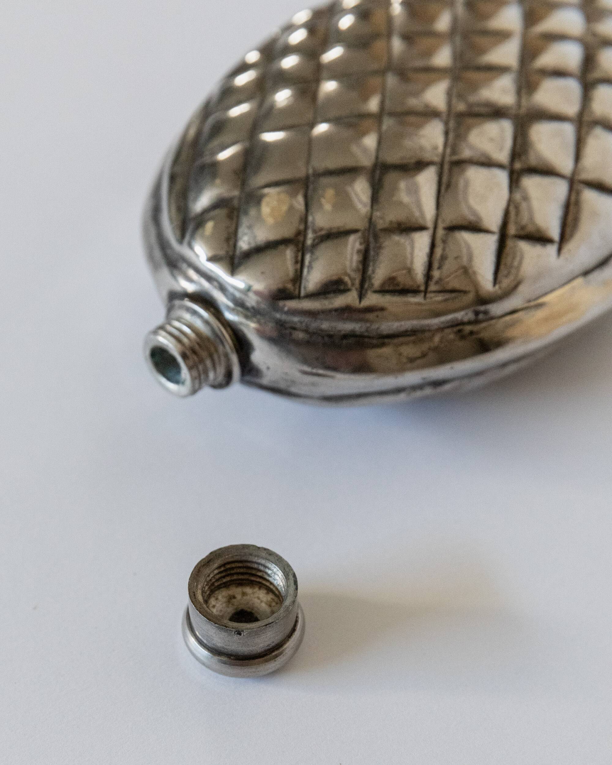 Vintage 1950s silver-plated flask in the shape of a pine cone.
