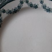 Old flat plates mismatched in iron earth accompanied by a serving dish