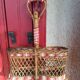 Bottle holder in braided wicker, rattan and scoubidou