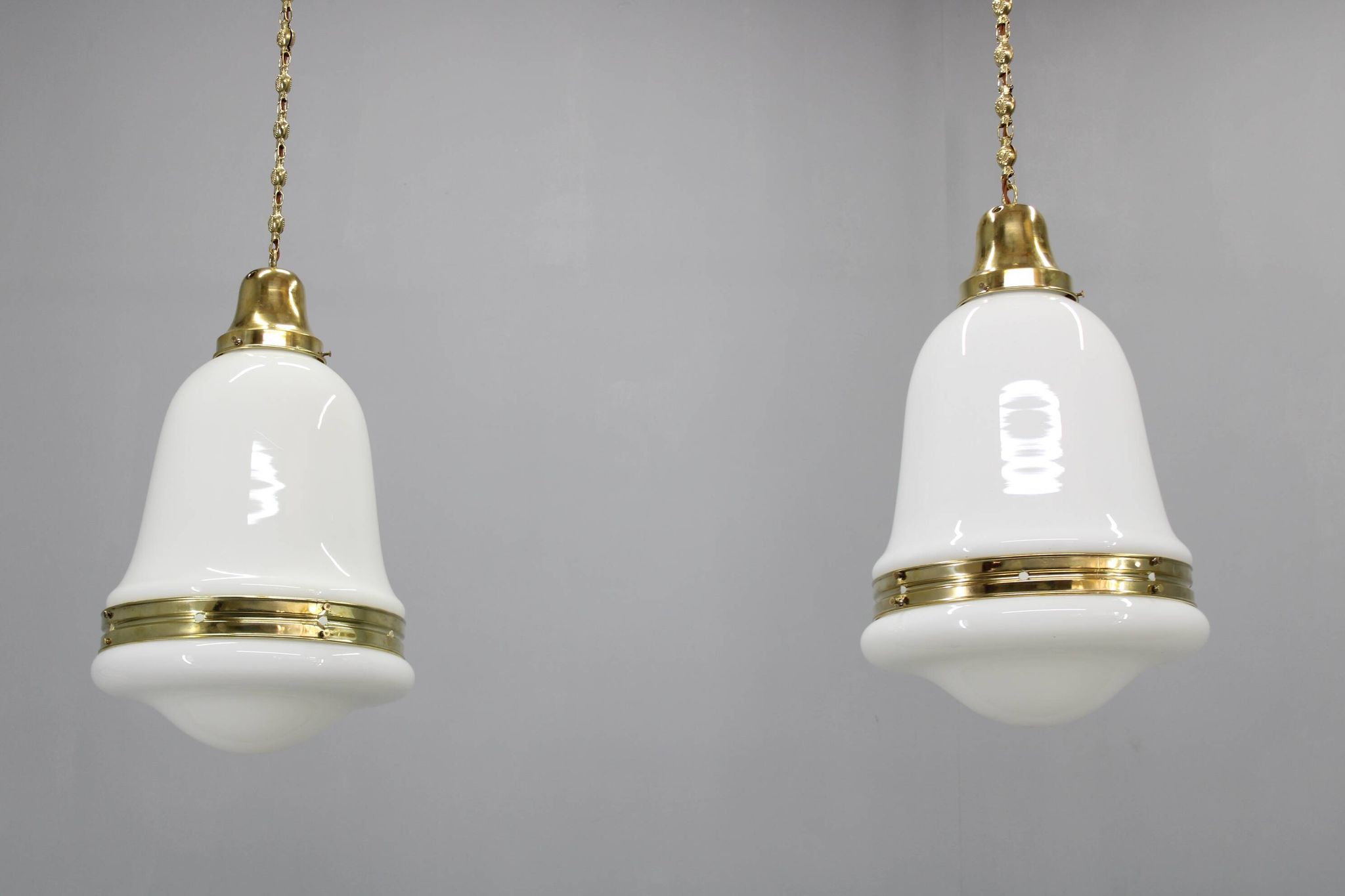 Pair of 1930s Peter Behrens Luzette pendants in opaline glass and brass