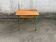 Vintage school desk made of wood and green metal - inkwell hole - antique.