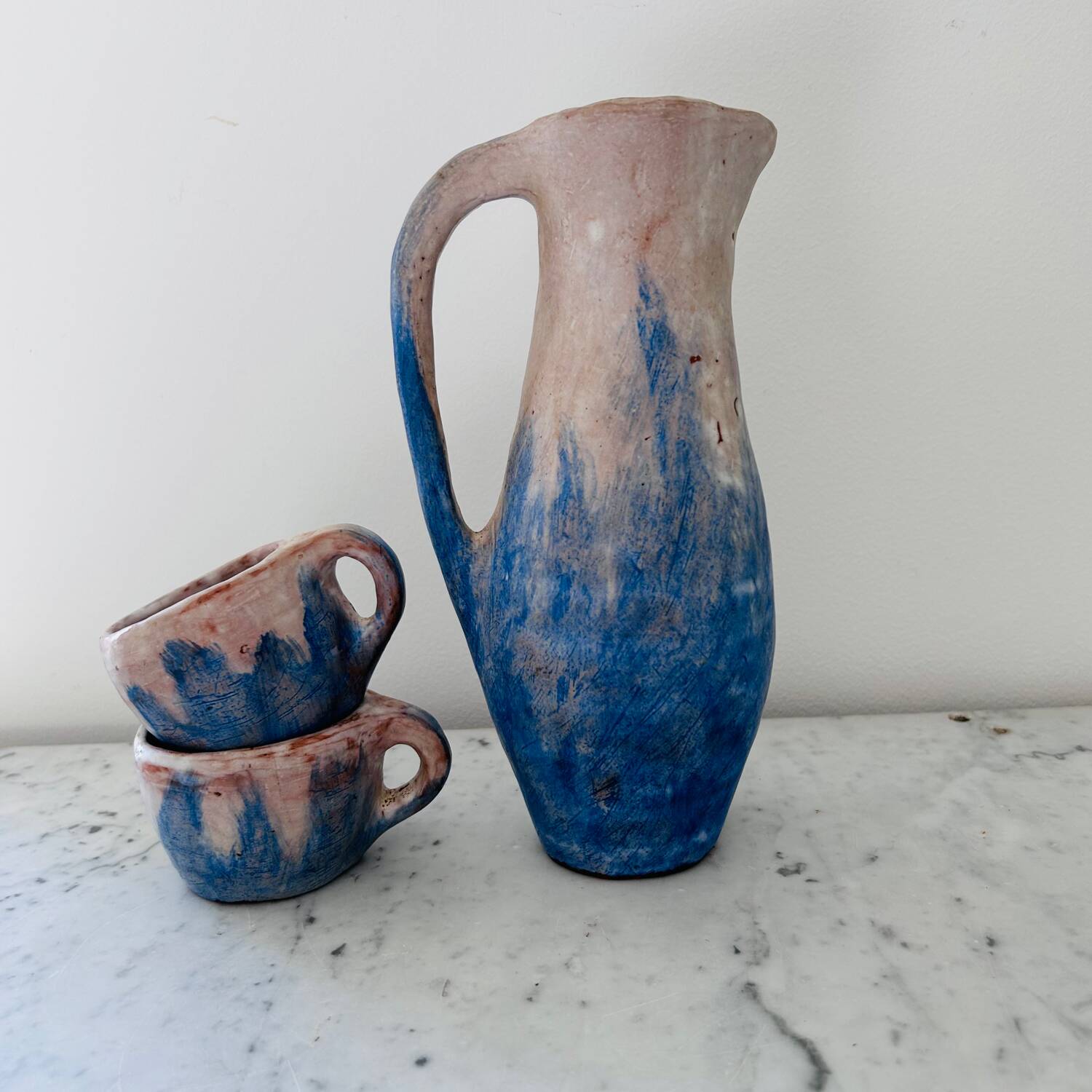Set of artisanal pitcher and weathered cups