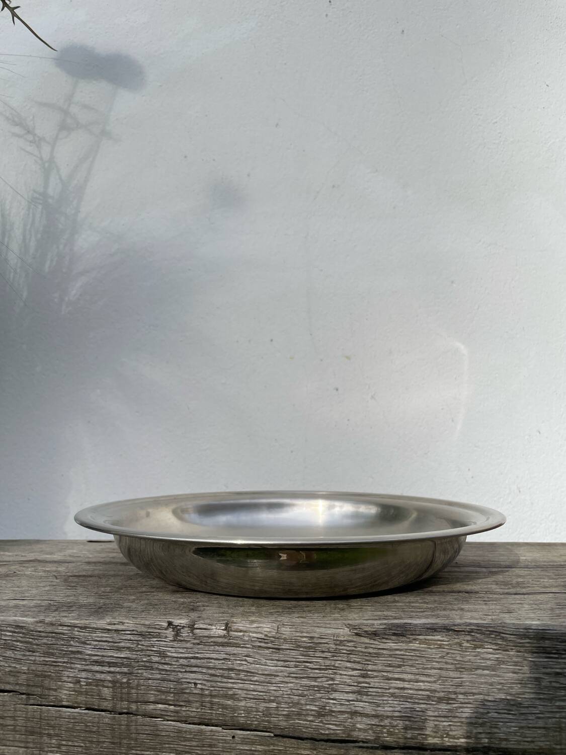Round silver-plated metal serving dish with hallmark