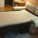Two-seater convertible sofa bed in off-white leather by Ligne Roset.