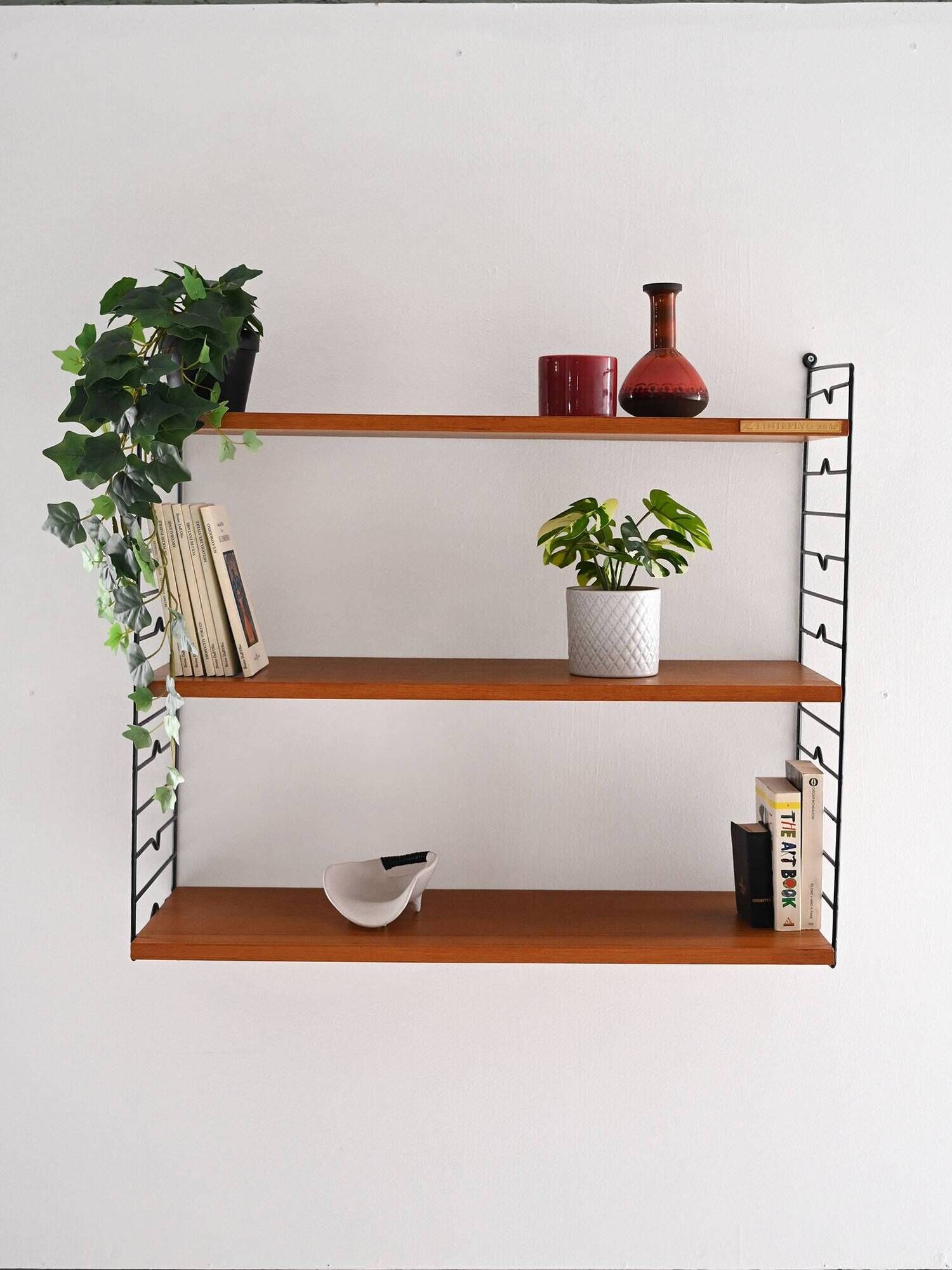 Scandinavian Hylla teak wall shelf with brass label