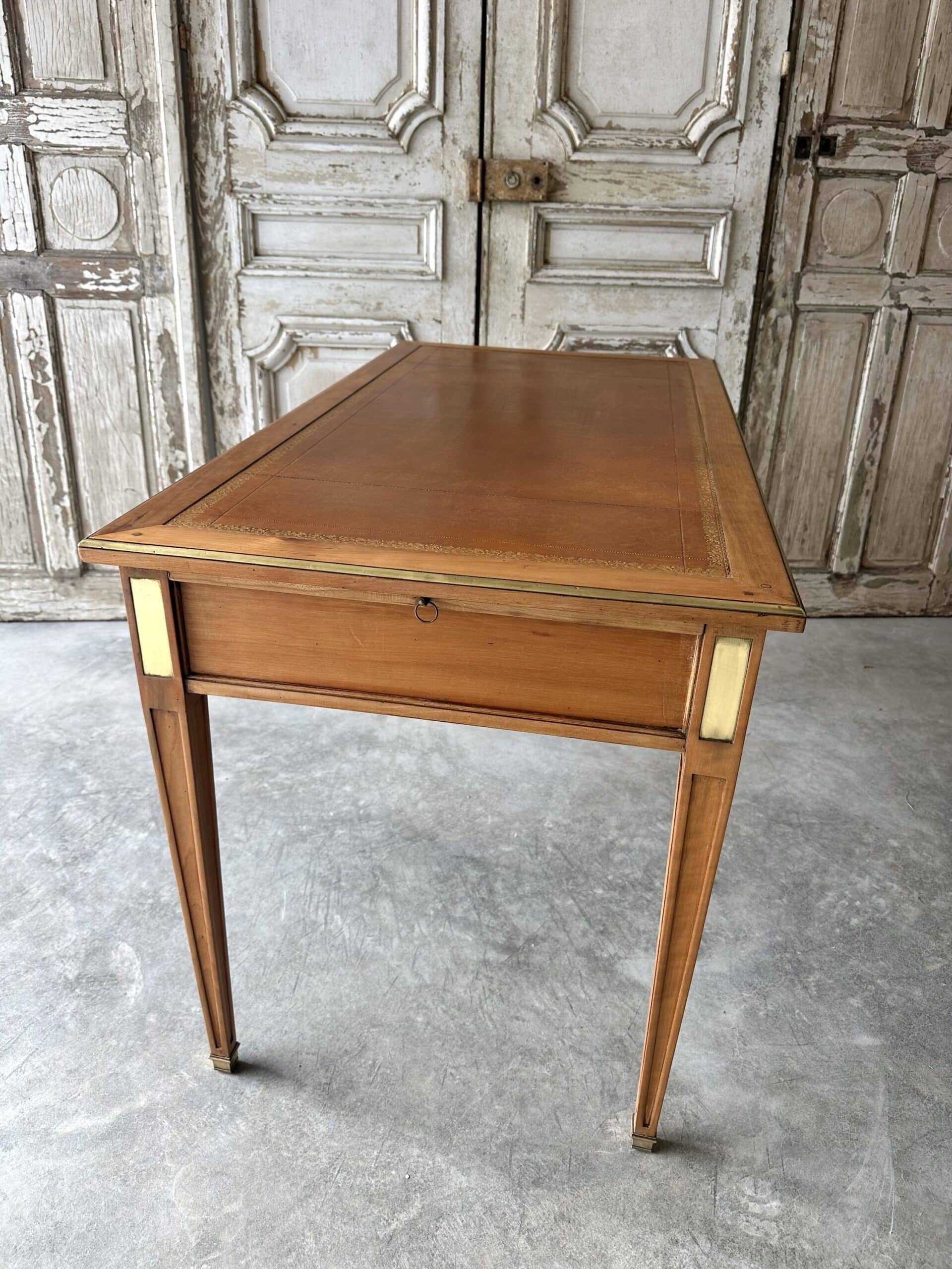 Directoire style flat desk circa 1960 in light cherry wood.