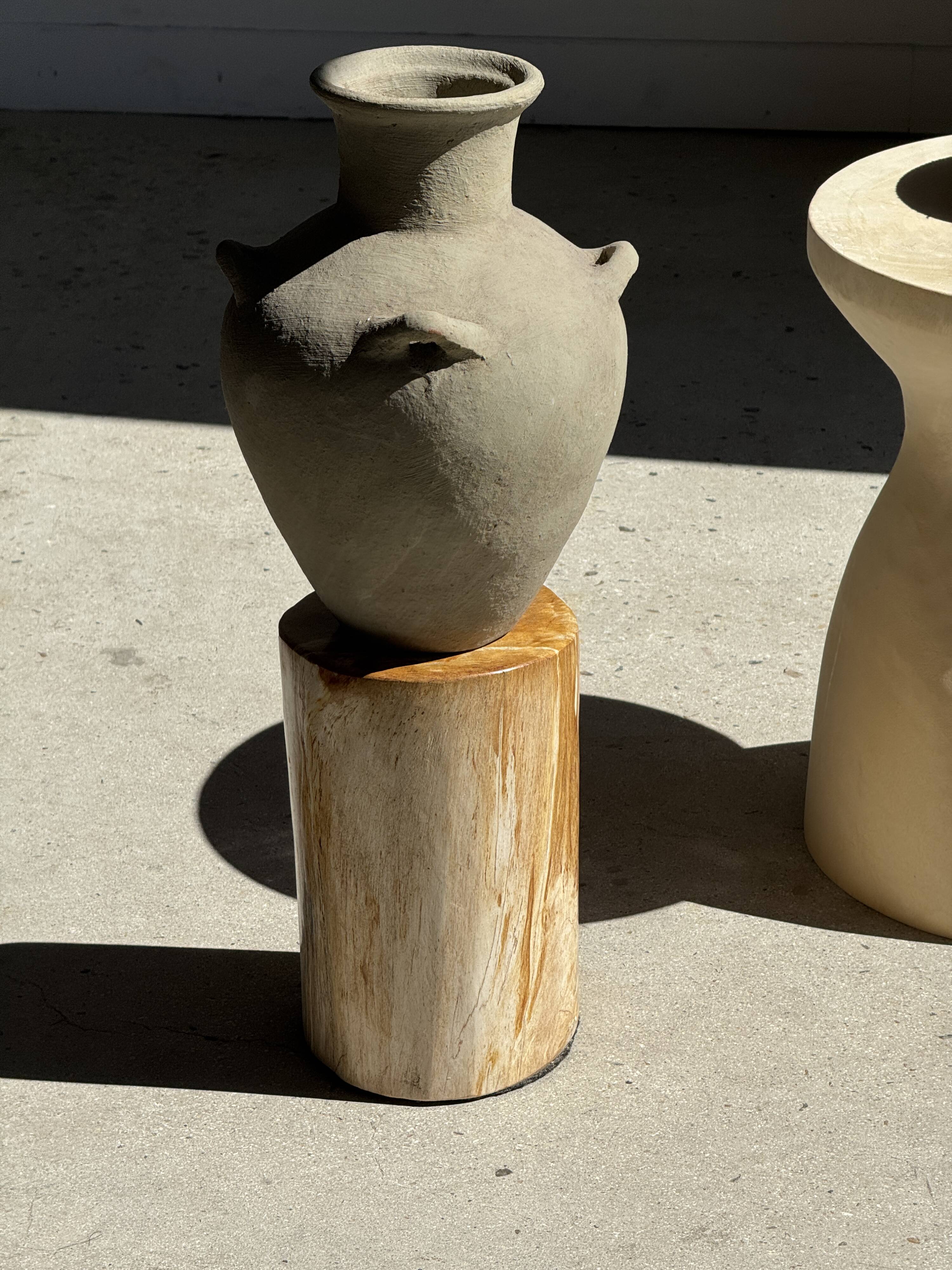Light beige-grey Indonesian terracotta vase with 4 small handles and a high neck.