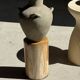 Light beige-grey Indonesian terracotta vase with 4 small handles and a high neck.