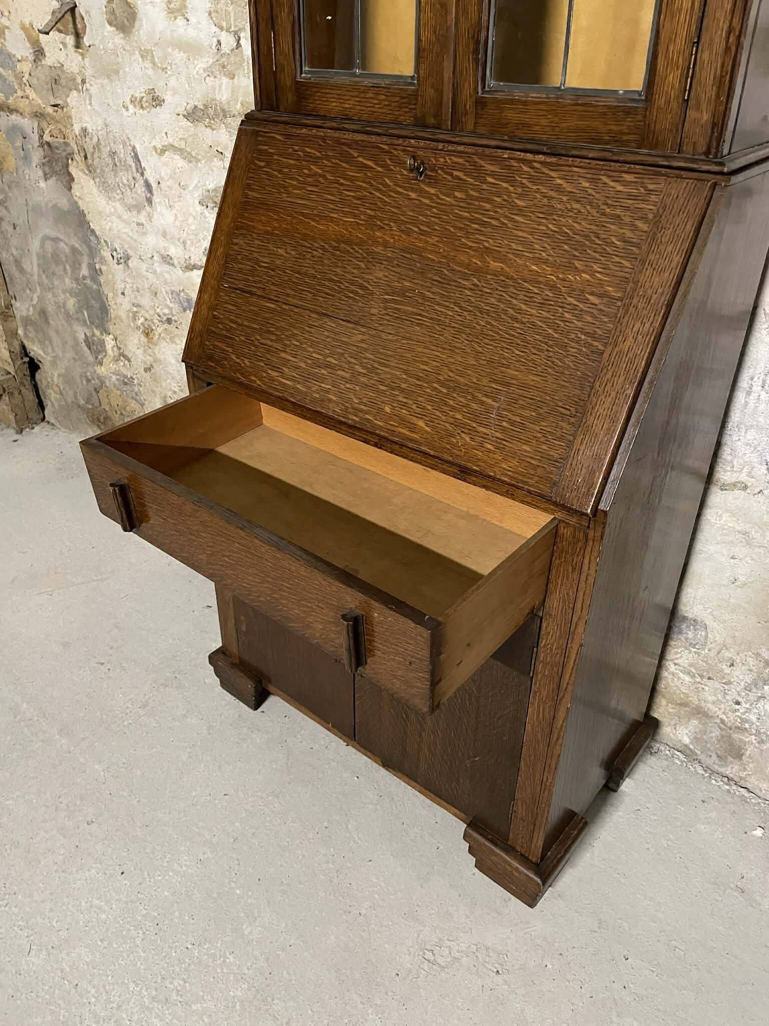 Oak display secretary cabinet with drop-down front, two sections.