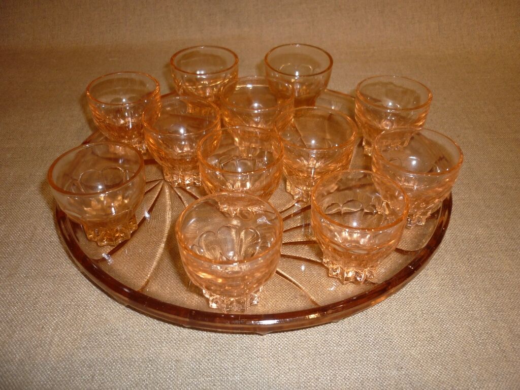 12 shot glasses on pink glass tray