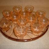 12 shot glasses on pink glass tray