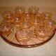 12 shot glasses on pink glass tray