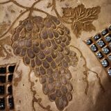 Empty pocket in openwork copper, chiseled and painted vine branches