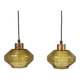 Hanging lamp with an outer shade of olive green glass and an inner shade of clear, crystal glass.