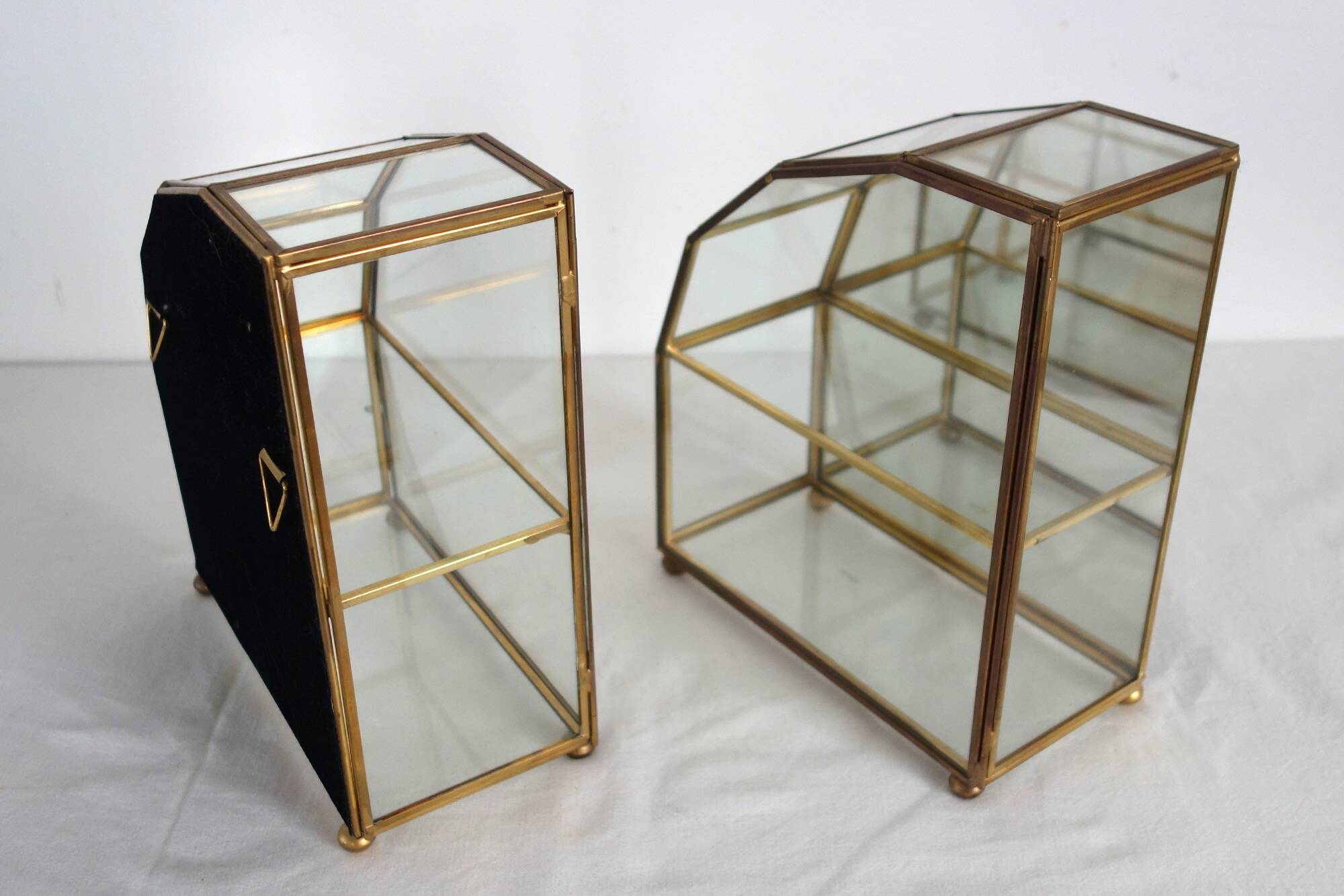 Pair of gilded brass, glass, mirror display cases from the 60s