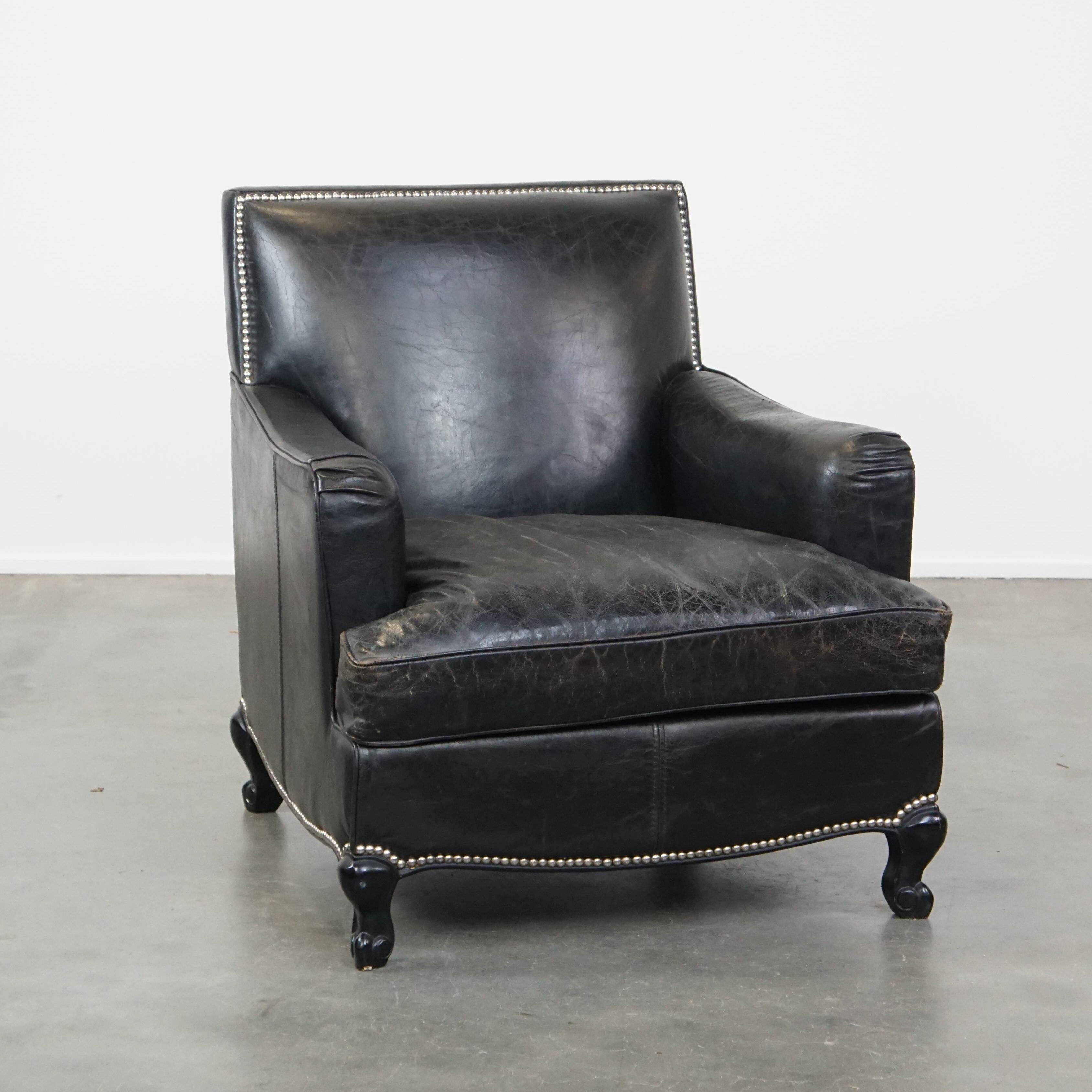 Armchair in black grained cowhide leather with a deep seat