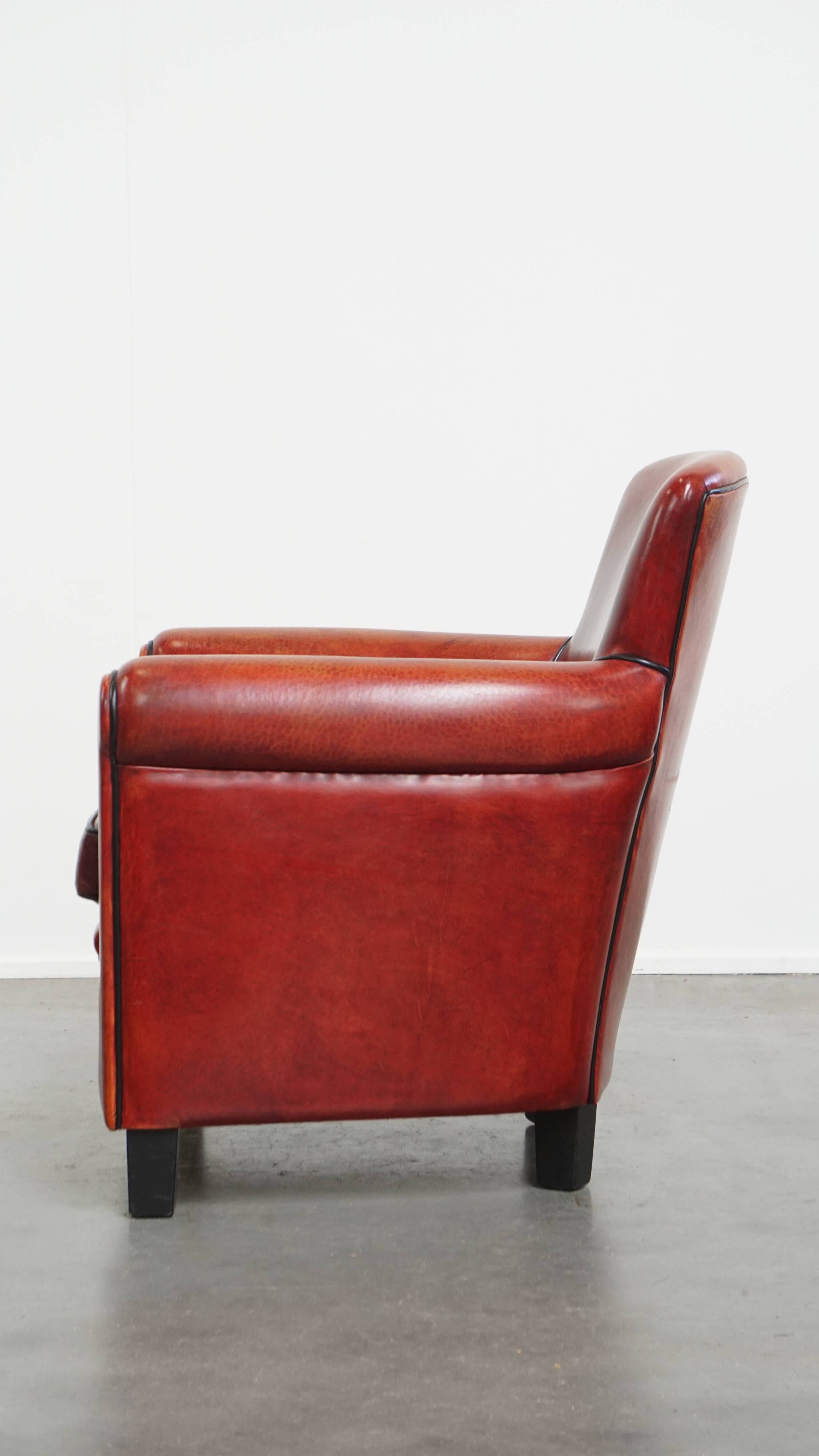 Armchair made of sheepskin leather in a red/brown color