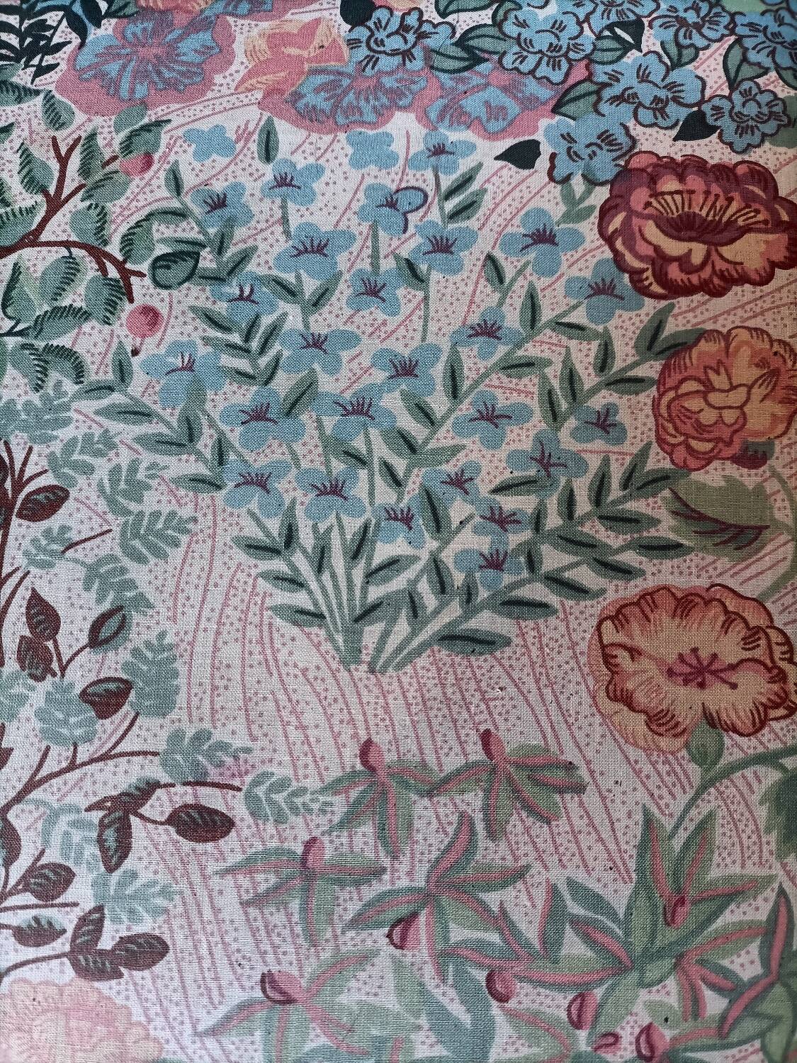 pair of toad armchairs in floral fabric.