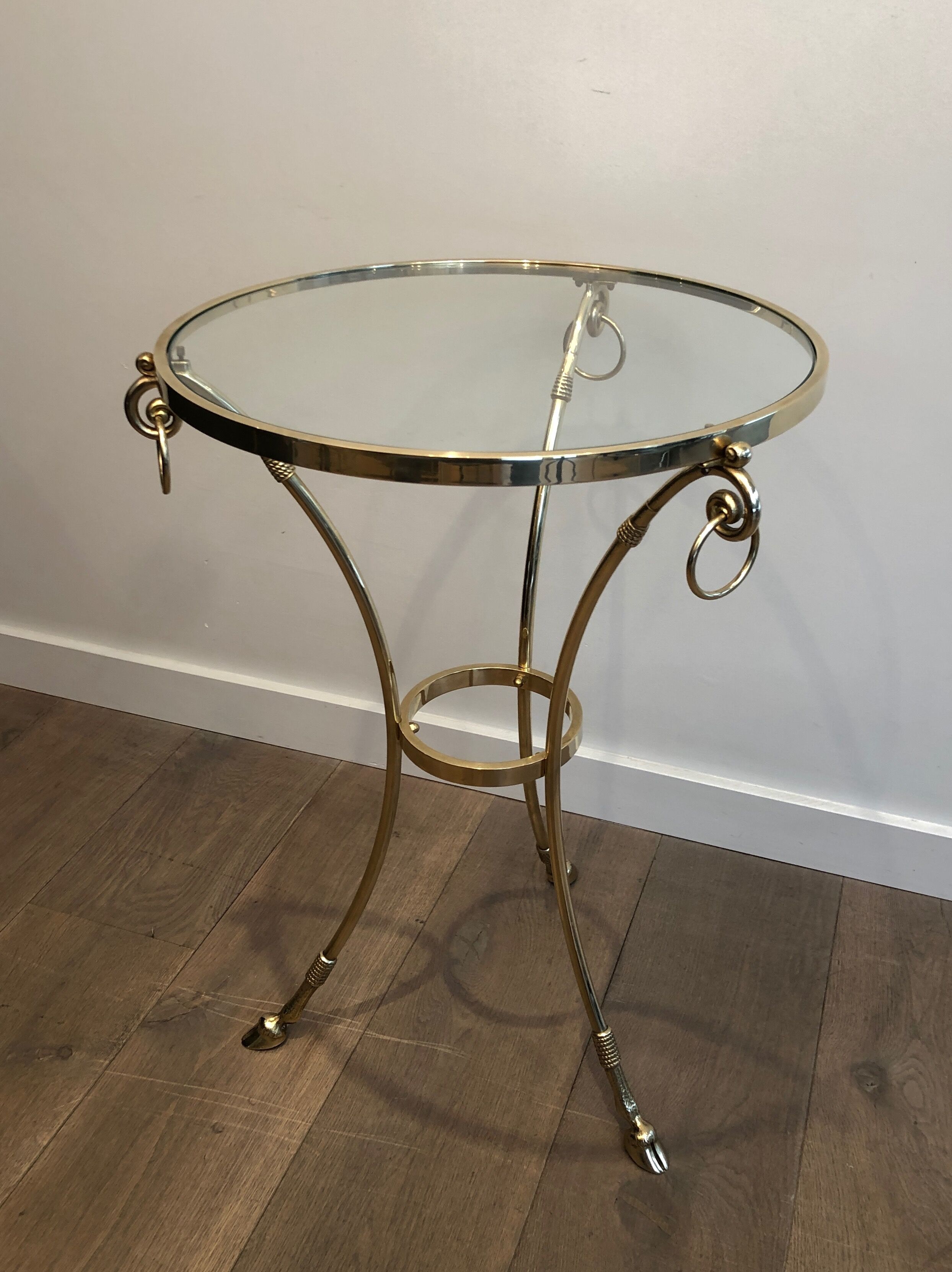 Neoclassical style tripod pedestal table in brass and round glass top in the taste of the House
