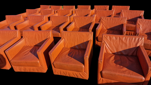 Pair of vintage orange leather armchairs