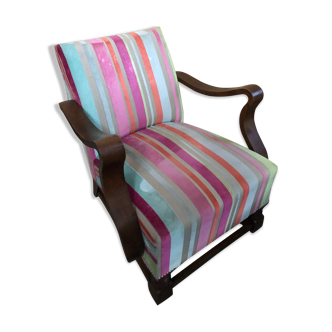 Old wooden armchair with curved armrests