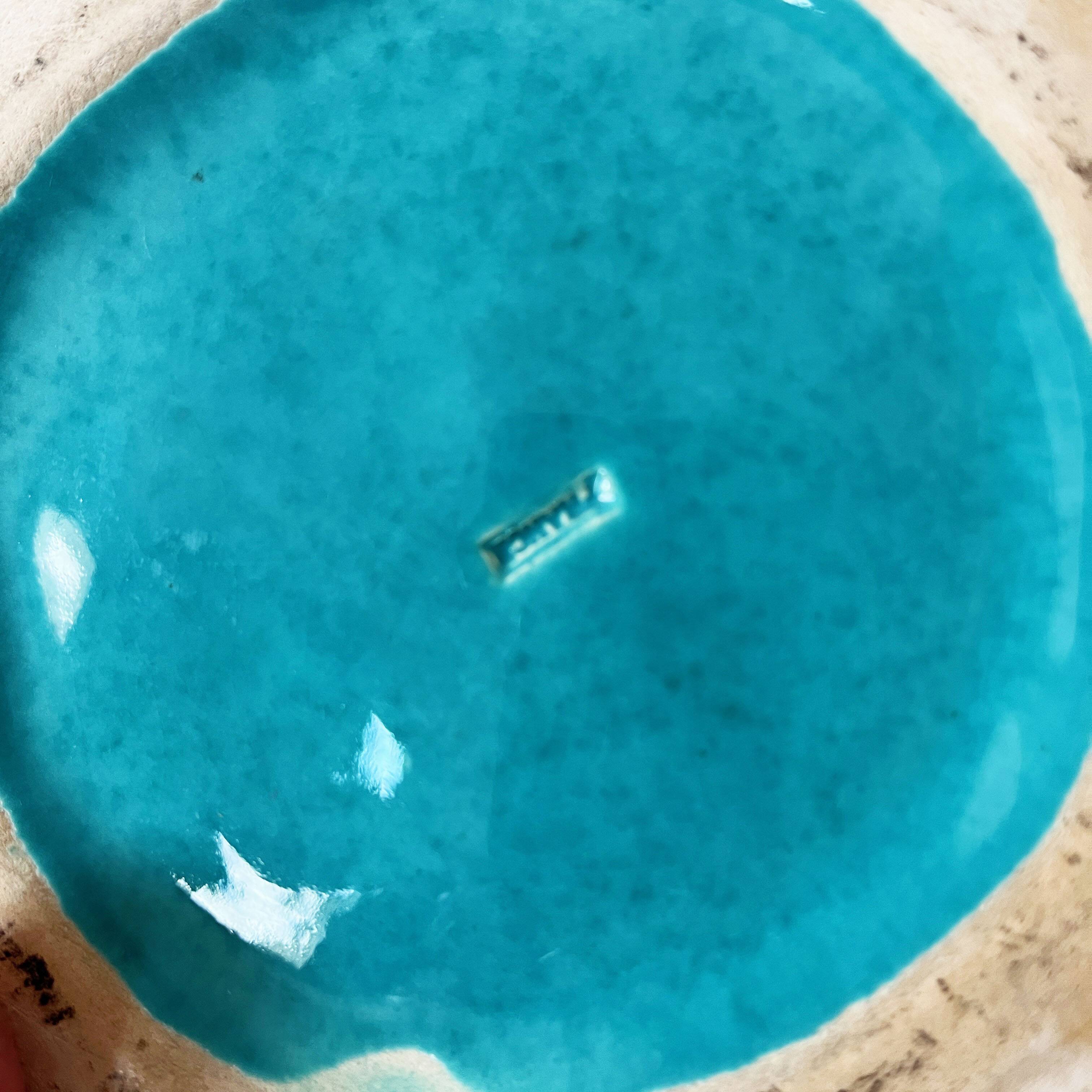 Ceramic trivet and bottle coaster from the 1950s.