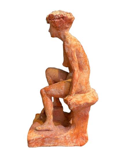 Painted plaster sculpture of a nude woman on a bench