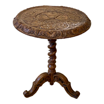 Carved wooden pedestal table