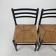 Set of 2 black and straw modernist side chairs, 1960s