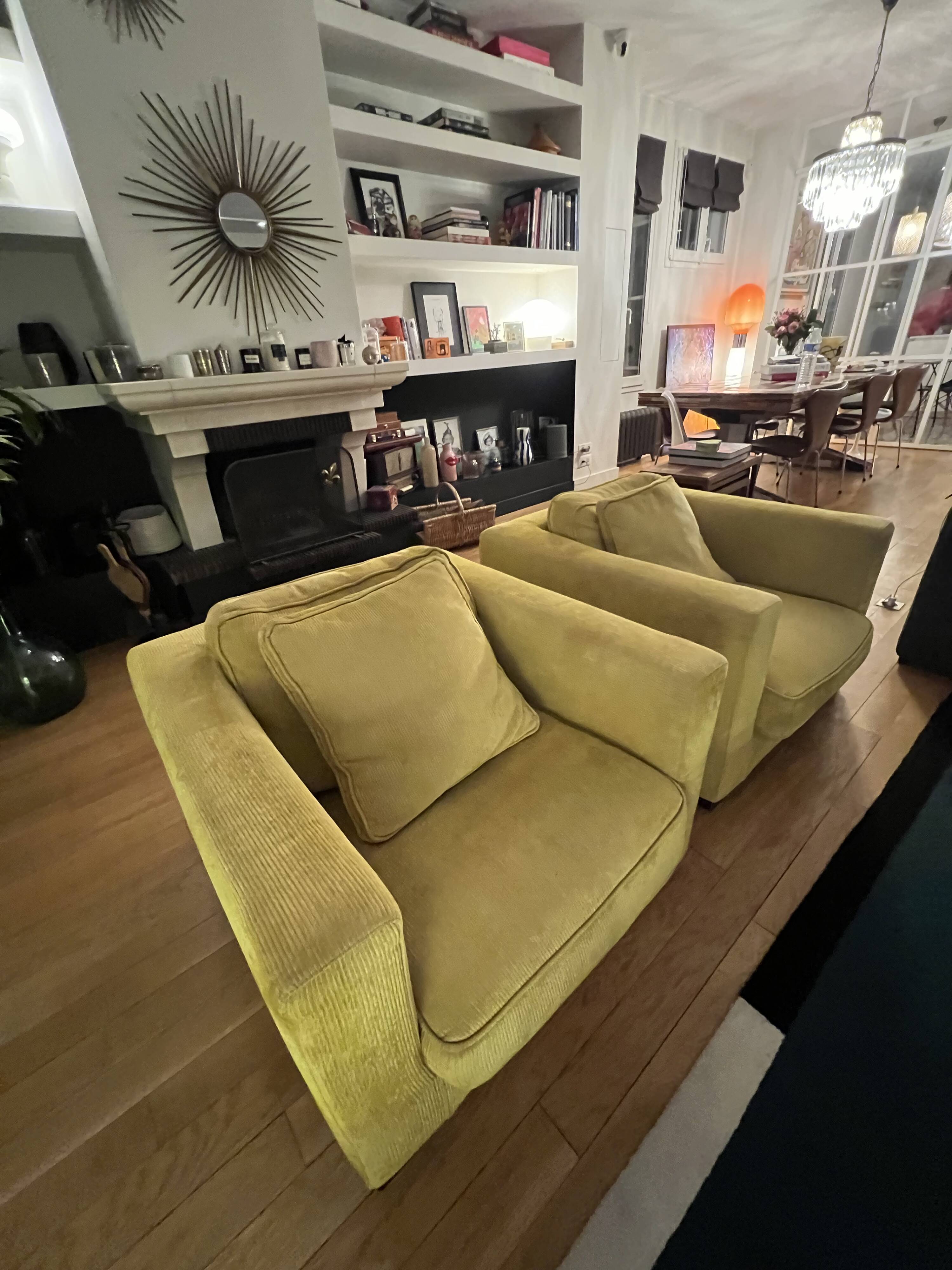Two yellow Roche Bobois Longislande armchairs.