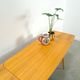 Vintage veneer table with pretty angular legs and brass at the base of the legs.