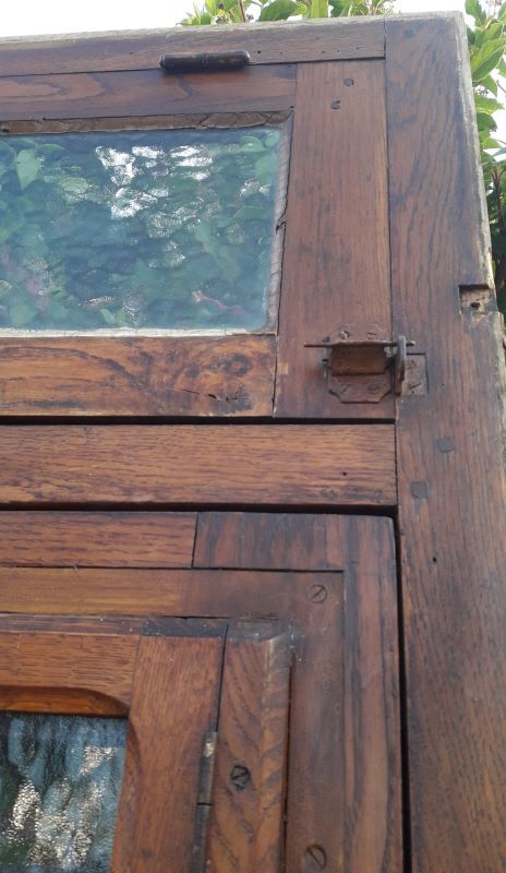 Oak entrance door and its frame and transom, wrought iron gates
