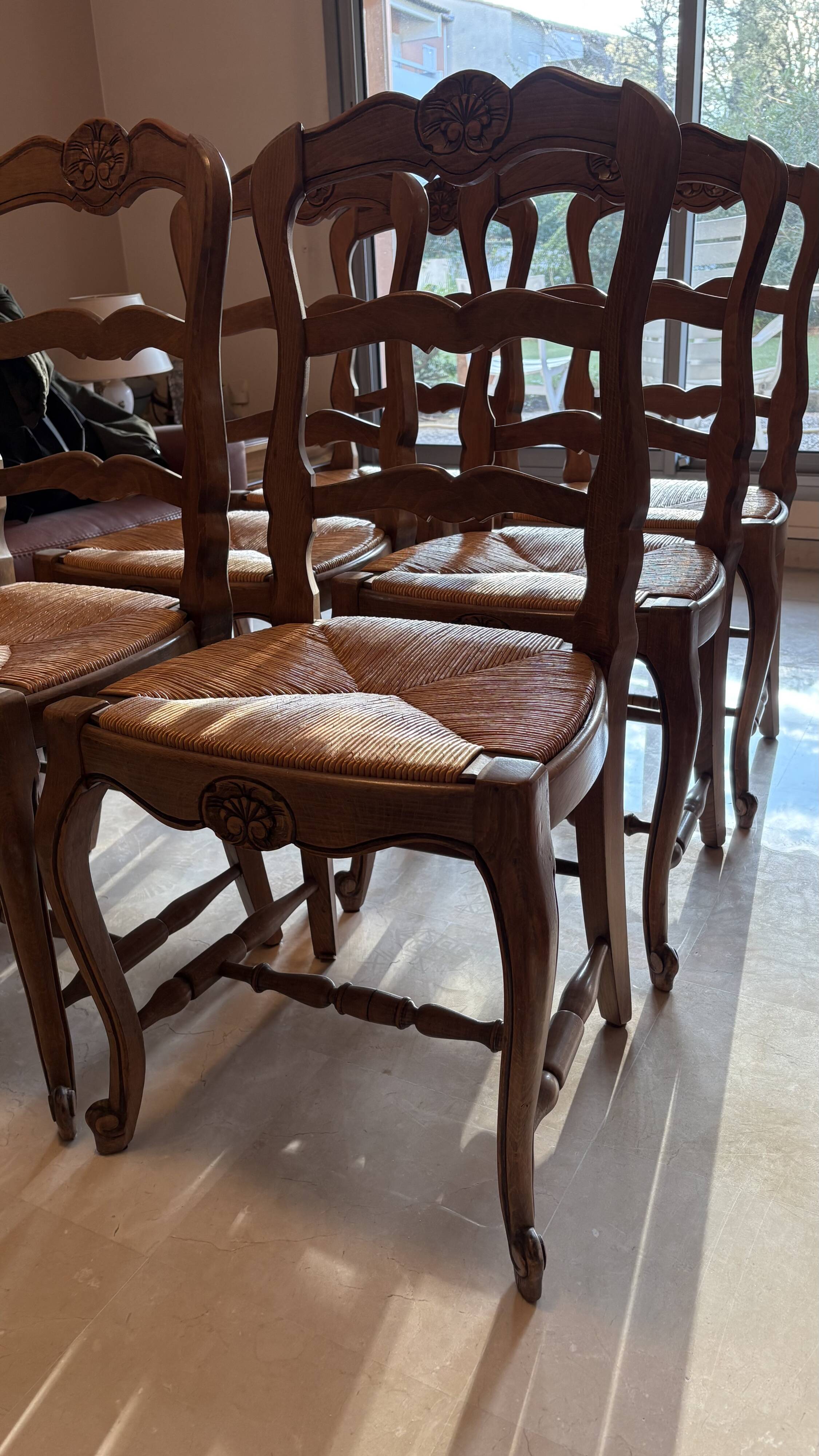 Set of 6 wooden chairs with straw seats.