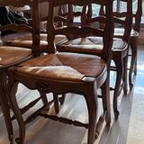 Set of 6 wooden chairs with straw seats.