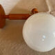 Vintage wooden globe wall light in white glass