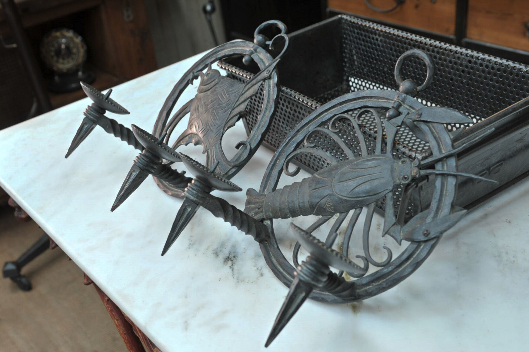 Pair of carved metal wall lamps signed RG