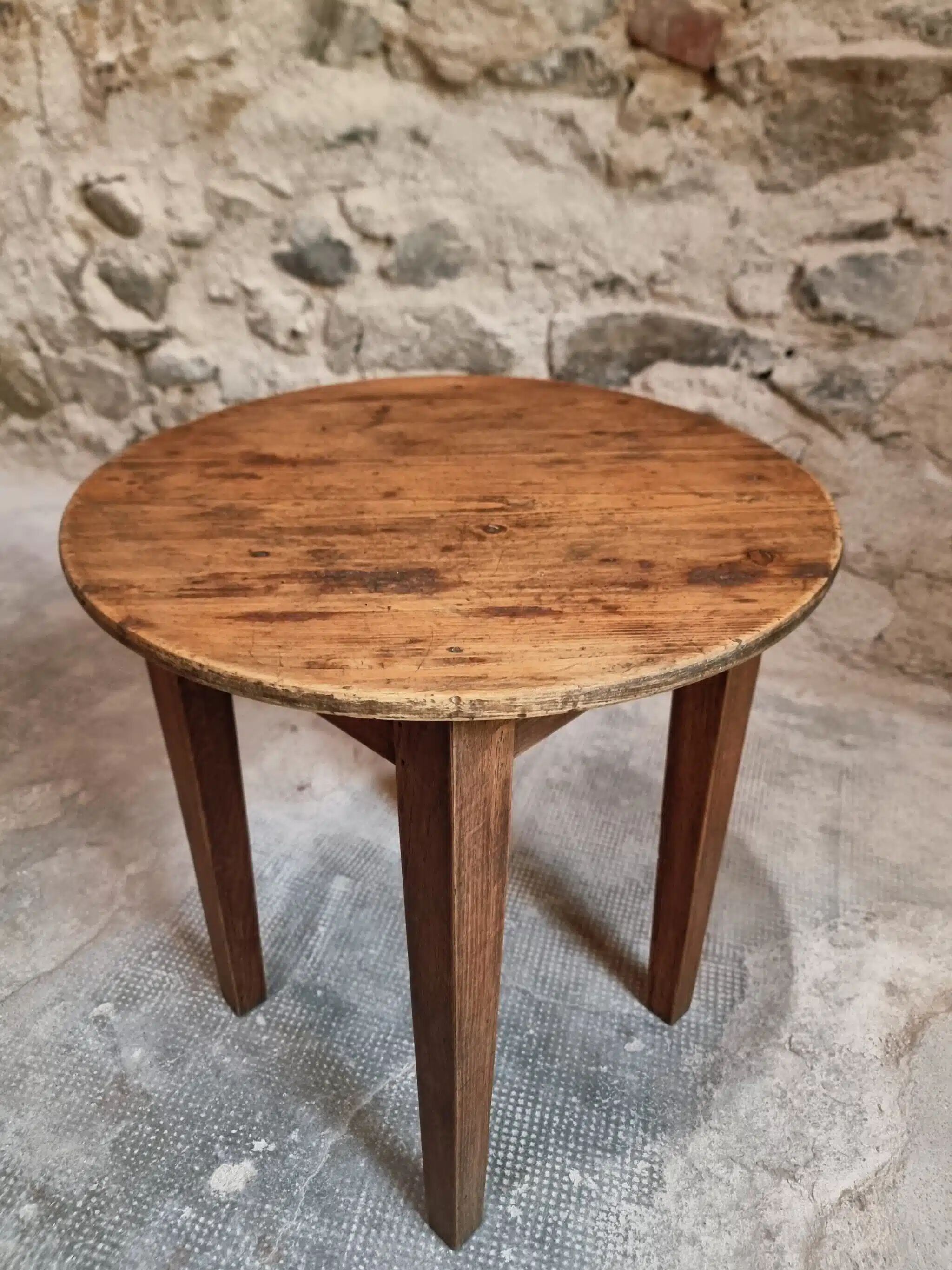 Antique round side table with oak legs and a pine top, circa 1900.